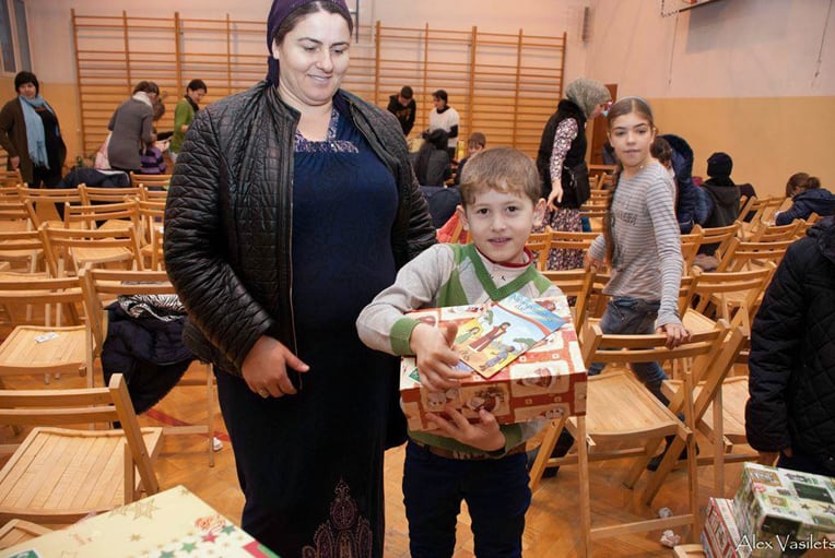 A refugee child with his shoebox gift.