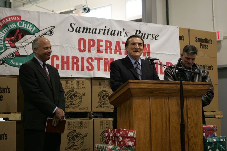 The late Ross Rhoads, center, Samaritan's President Franklin Graham, and Operation Christmas Child Vice President Jim Harrelson celebrate the delivery of shoebox gifts around the world.