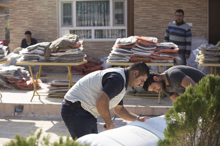Local staff and partners prepare for a clothing distribution near Dohuk.