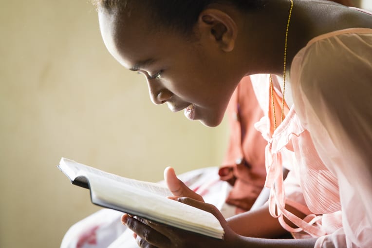 This participant in The Greatest Journey discipleship program in Fiji pores over the Bible she received at graduation.