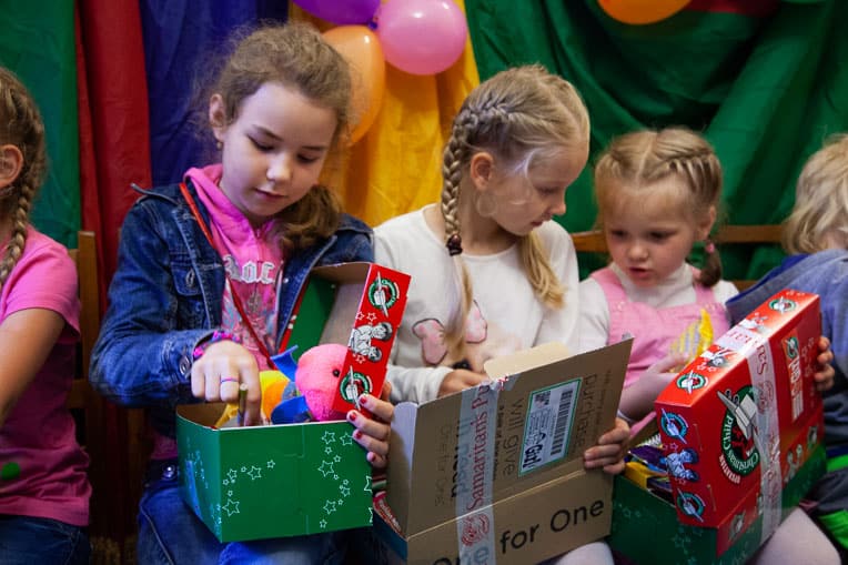 Children enjoy discovering the new treasures inside their shoebox gifts in 2015.