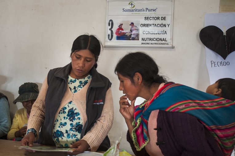 Cristana reviews nutritional instructions with a mother.