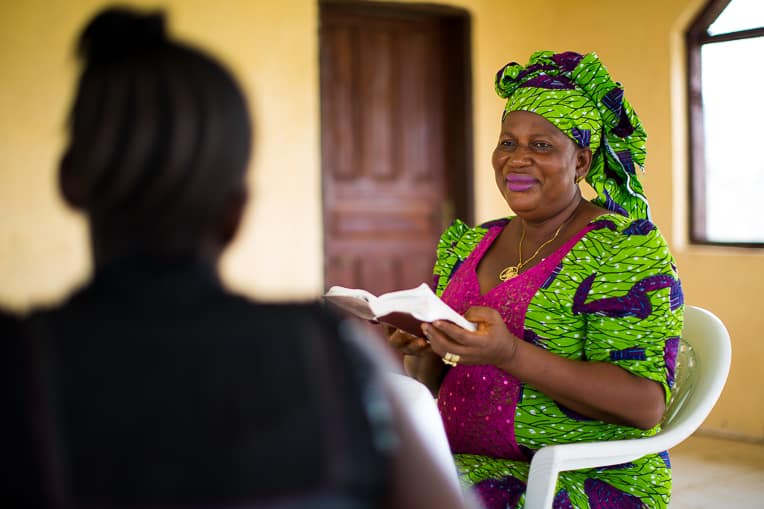 Ma B encourages the women at her safe home with the Word of God.