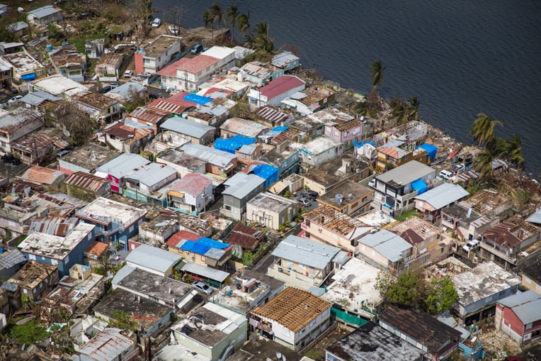 Hurricane Maria ripped off many roofs in this neighborhood near the shore of Laguna Los Corozos. Our blue shelter tarps are helping prevent further damage.