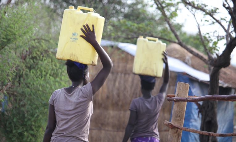 Water is a constant need in the refugee settlement camps. Women are often in charge of gathering water.