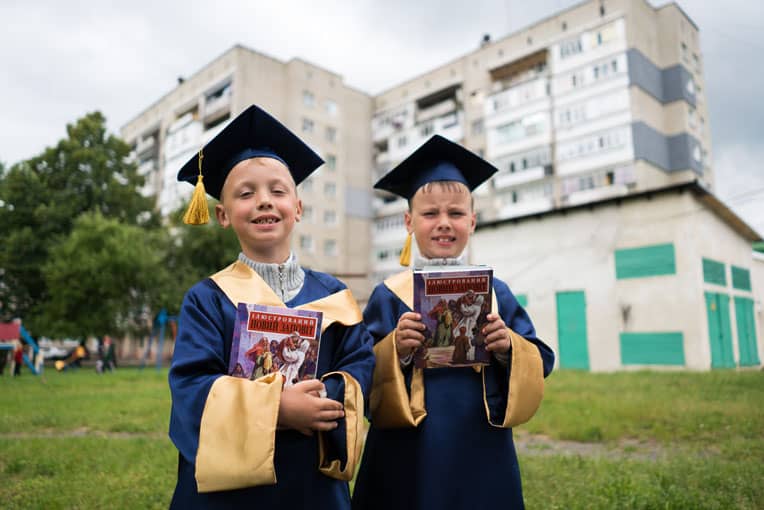 Twins Vladik (left) and Vitaly received Bibles at graduation to help them grow in the Lord and continue sharing Him with others.