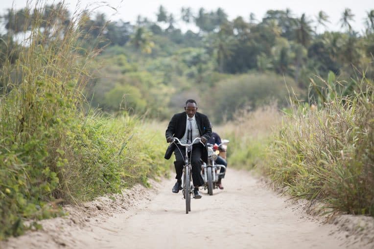 Pastor Marco Ayuba rides his bike two hours to lead his church plant, Maranatha Church Kitomondo.