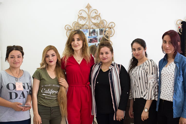 Sarina (second from left) and Marwa (third from left) with ladies in the Northern Iraq Community Center salon.