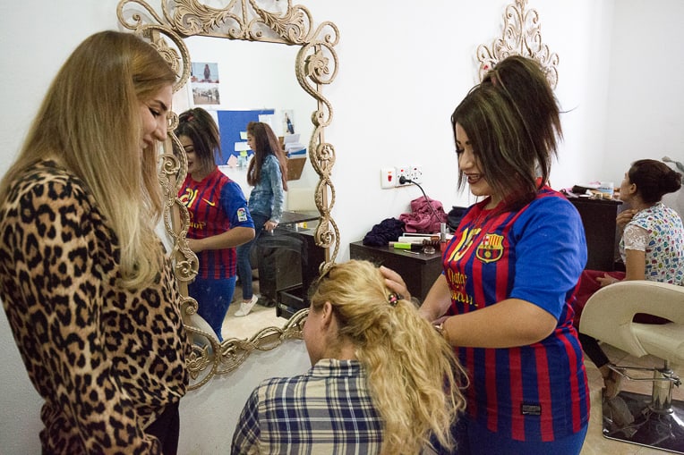 Angel (right) learns how to become a beautician from her instructor Marwa (left).