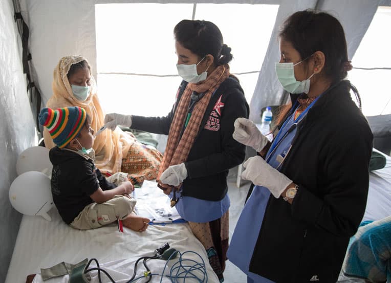 Nurses care for Mahamuda's grandson, Humial.