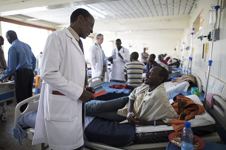 Chaplain Elijah Bii, left, shares the Gospel with Geoffrey.