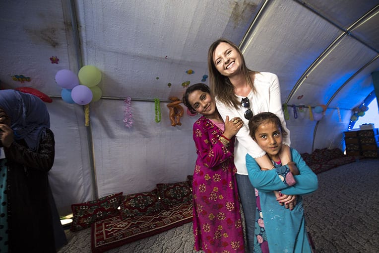 Jessica Langevin (center) rejoices with two child-friendly space participants after their graduation.