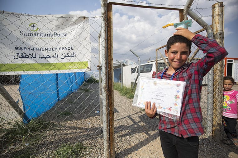 A graduate shows off his diploma.
