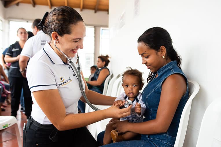 Nurse/chaplain Liyineth Espejo works with Orangeles and her son at the Center of Hope in Cucuta, Colombia.