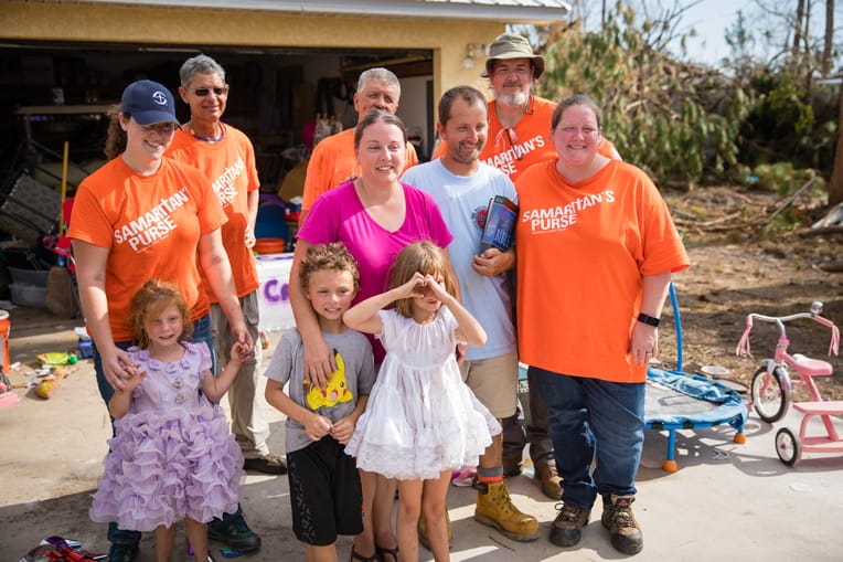 At the end of the workday William and Stephanie Cribbs gather with volunteers, including Kristy, outside their home near Mexico Beach.