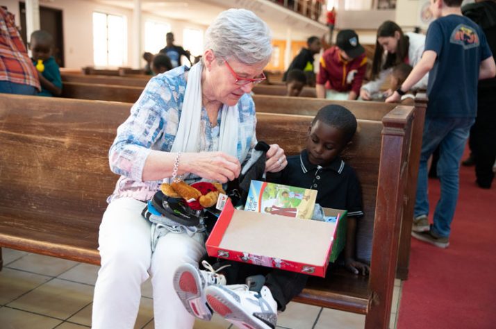 Jane Austin Graham, wife of Franklin Graham, enjoyed helping children with their shoeboxes.