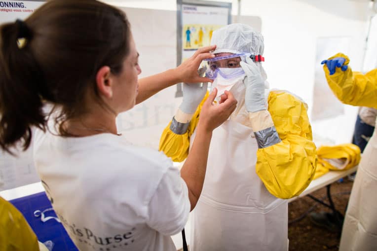 Our medical teams practice donning their personal protective equipment so that they can safely care for Ebola patients.