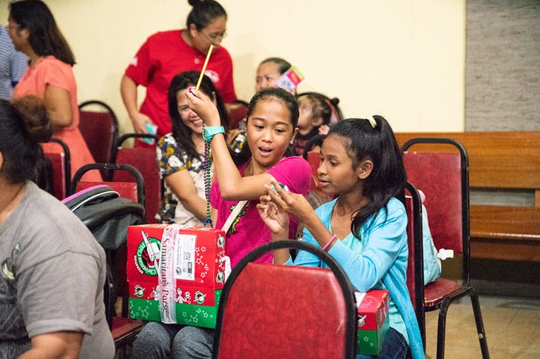 Eden, left, was excited to receive the gifts in her shoebox.