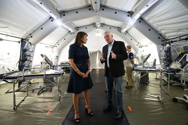 Samaritan's Purse President Franklin Graham provides former U.S. Ambassador Nikki Haley a glimpse of our Emergency Field Hospital on display at the conference.