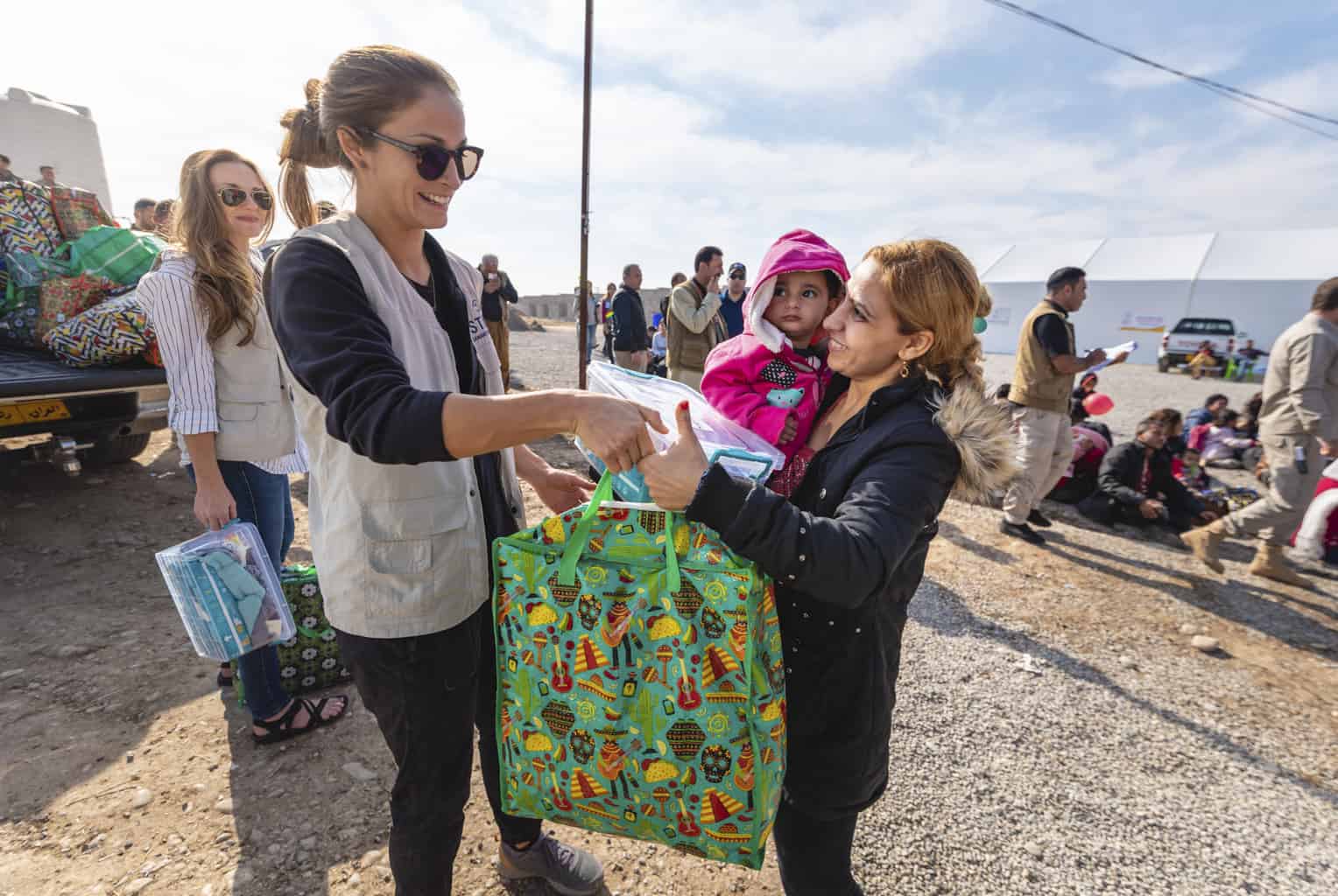 A Samaritan’s Purse staff member hands out dignity and hygiene kits to Syrian refugees at Sehela transit center.