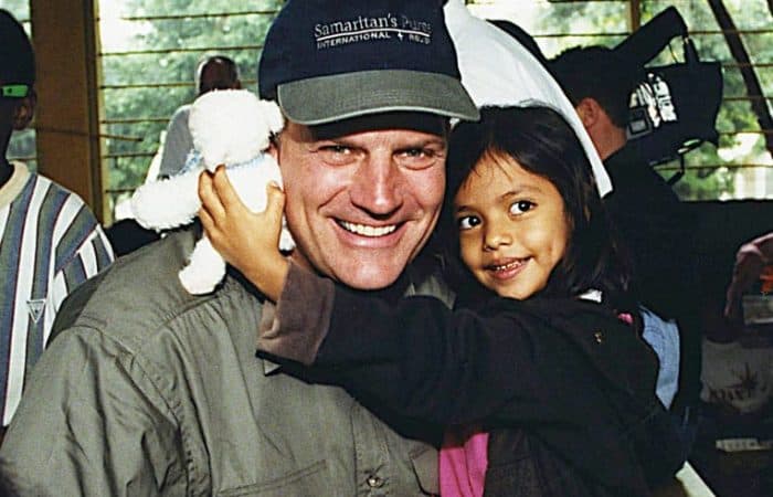 1999 - At a shoebox distribution in a Honduran orphanage, Franklin Graham sang “Jesus Loves Me” to Juni, who received a toy lamb that played that tune.