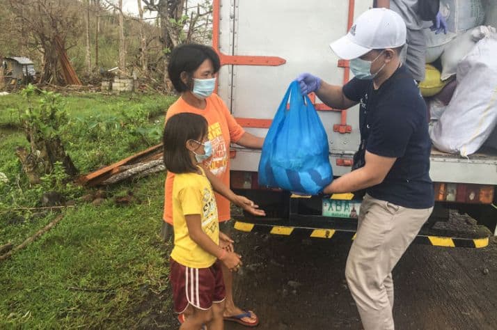 A family in the Philippines receives relief items from our staff.