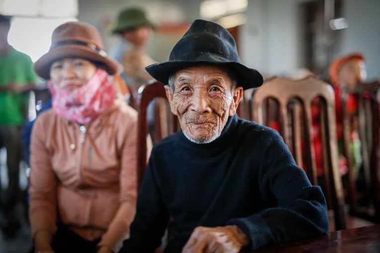 A beneficiary in Vietnam waits to receive his emergency supplies. Please pray for families suffering in the wake of these natural disasters.