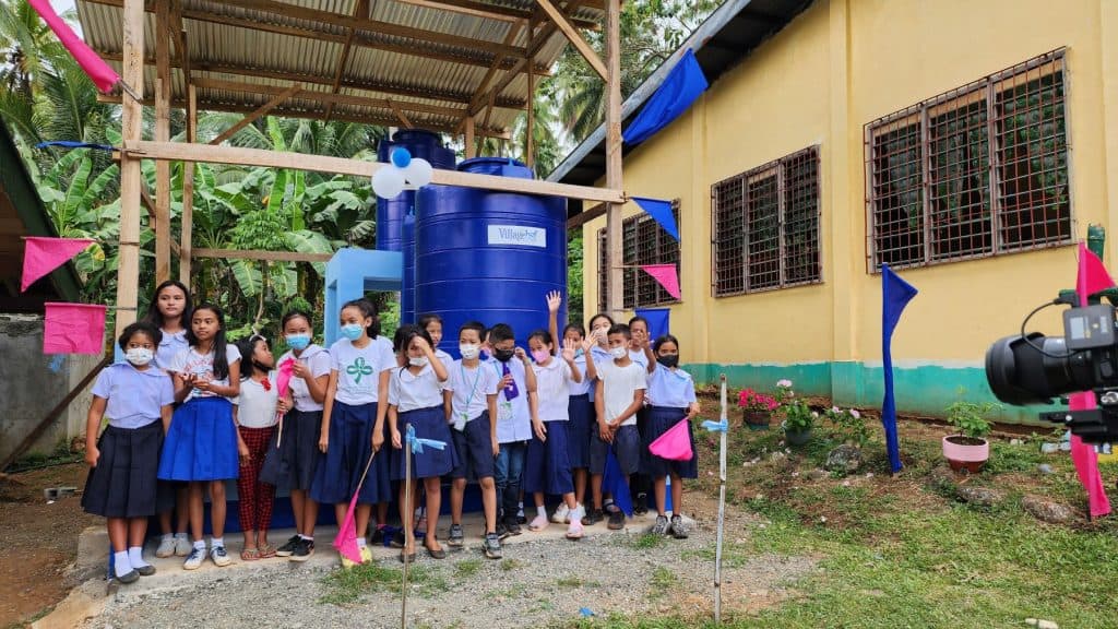 Alyna celebrates safe water with her classmates.