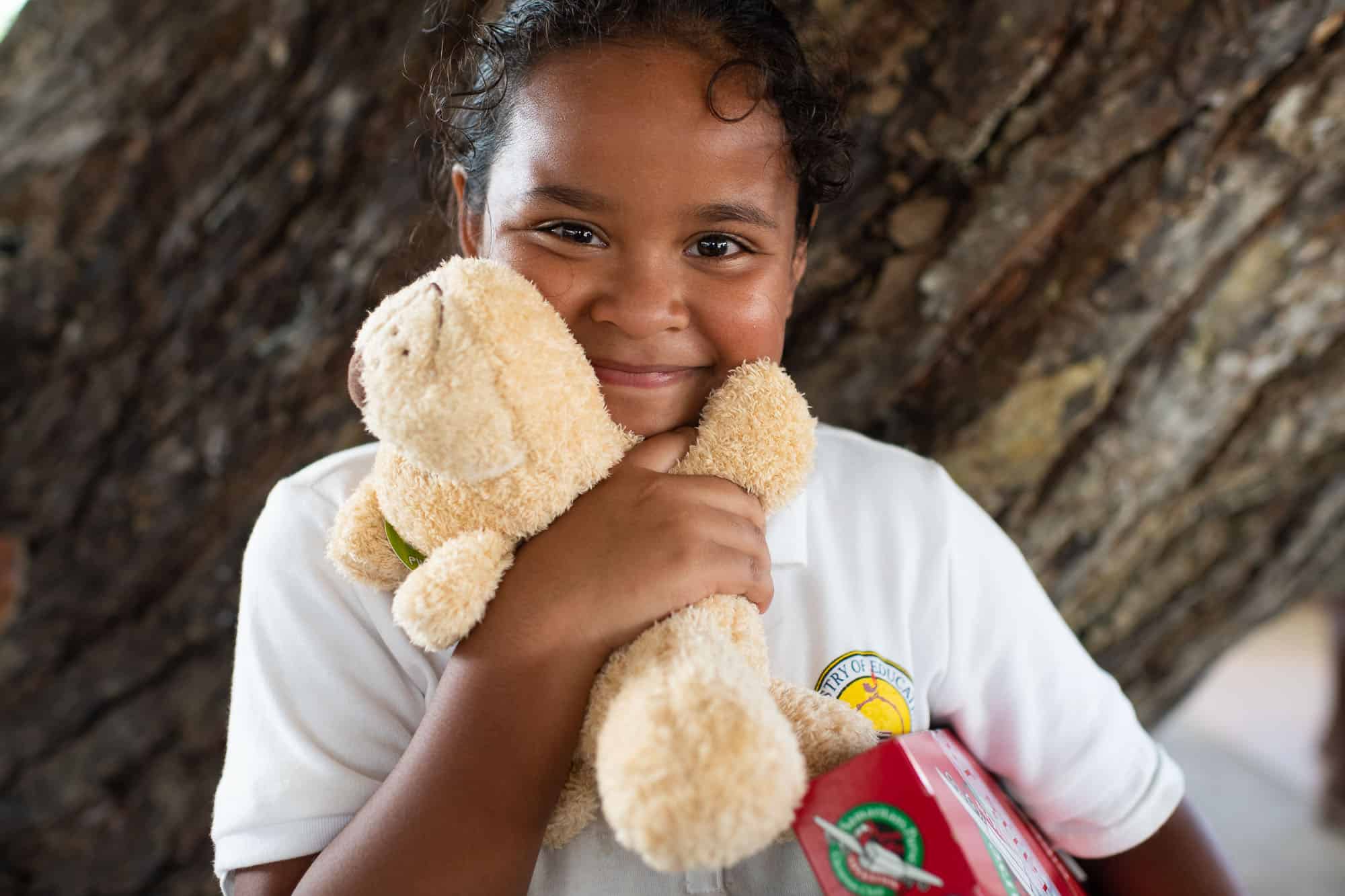 A girl on Ngiwal treasures the stuffed animal she found in her shoebox gift.