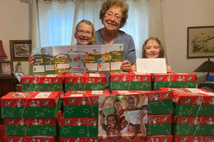 Lula Singletary celebrates completing her first 101 shoeboxes of the season together with great-grandchildren Lily (left) and Iris (right).