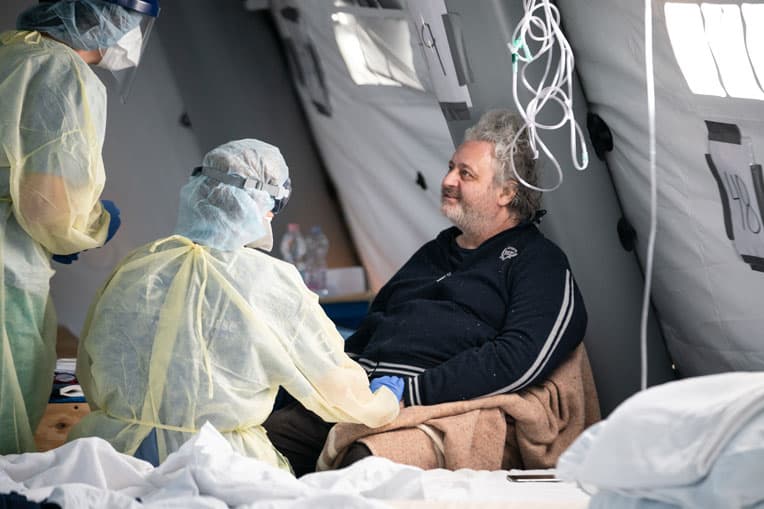 Umberto speaks with his doctor and a translator.