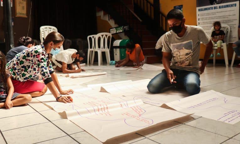 The family participates in an activity at our shelter to help them process their journey.