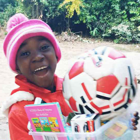 Unique especially enjoyed the soccer ball he found in his shoebox gift.