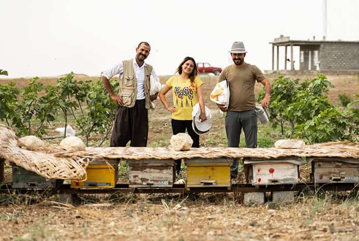Keko (left) enjoys training beginning beekeepers in the tricks of the trade.