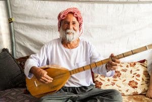 Roni plays his tambura for his bees.