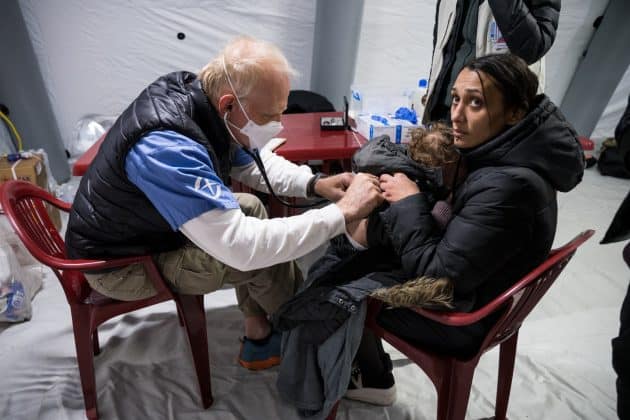 One of our doctors attends to a sick child with his mother at the train station clinic.