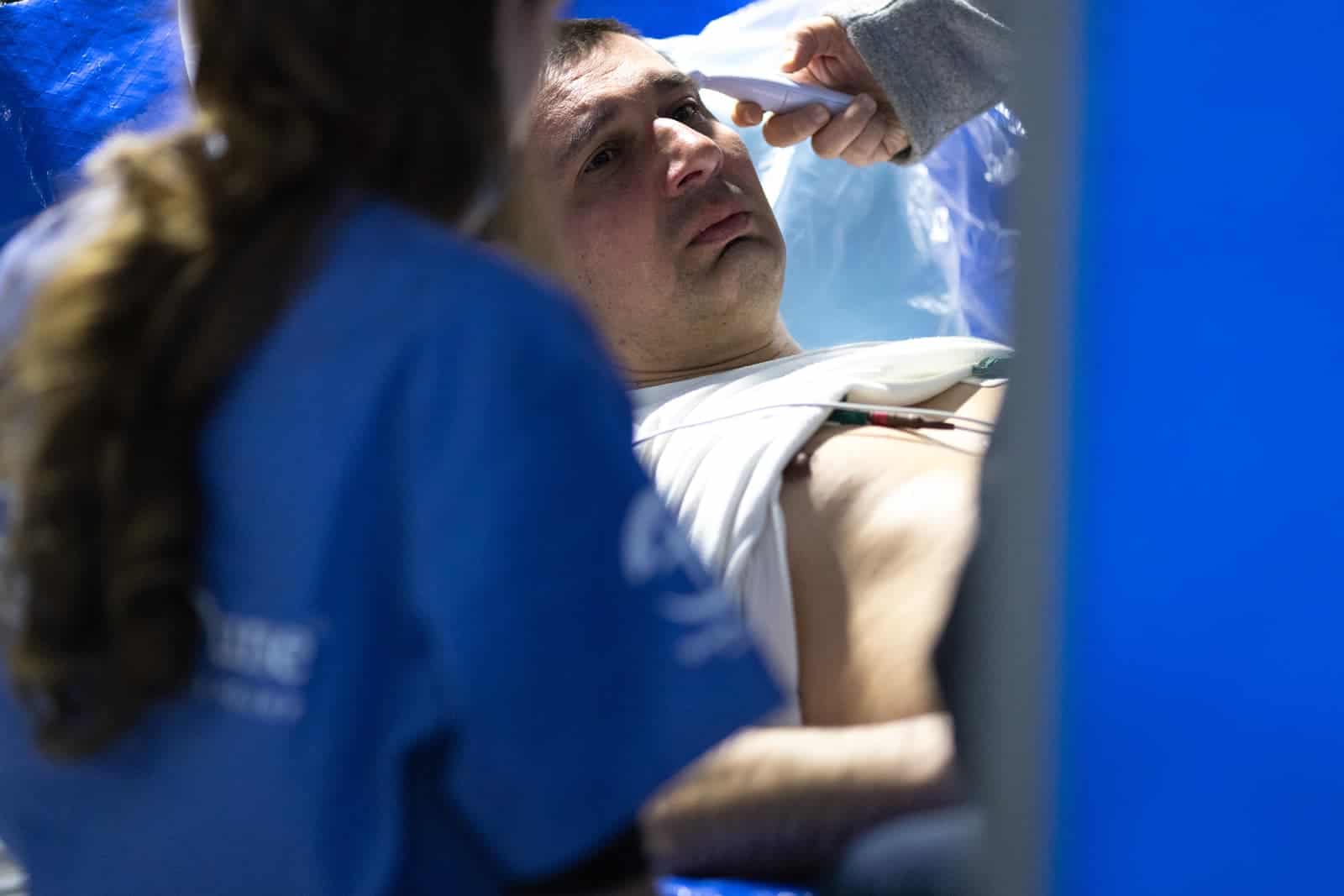 Comforting a grief-stricken man at our Emergency Field Hospital.