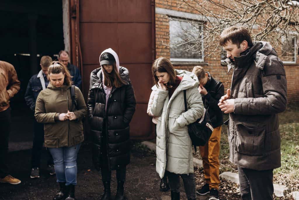 A local pastor named Benjamin prays over Samaritan's Purse staff and his congregation of volunteers before a day of distributions in Ukraine.