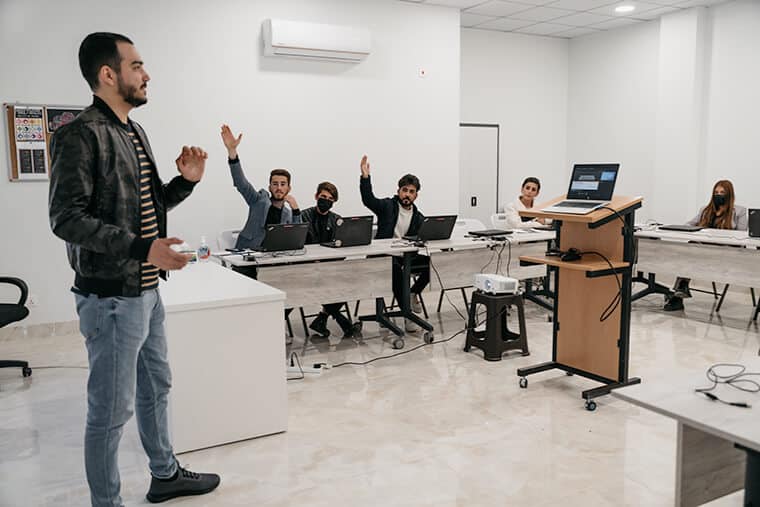 Khalil teaches a computer class to Salim (second from left) and other eager students.