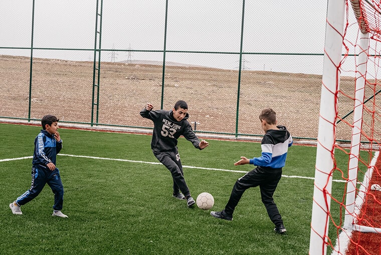 Children enjoy some fun moments on the soccer field that sits on the edge of the new community.