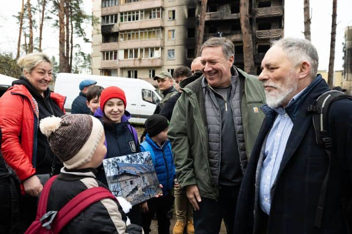Mike Pompeo greets a child during the U.S. delegation’s visit to Ukraine.