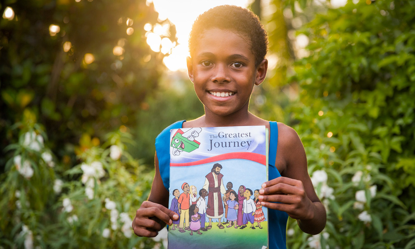 A group of children gather with their Operation Christmas Child shoebox gifts as local believers share the hope of the Gospel.