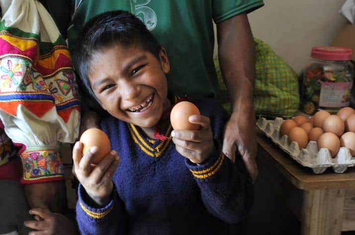 Andy, 7, proudly shows off the eggs his parents sell at their store.