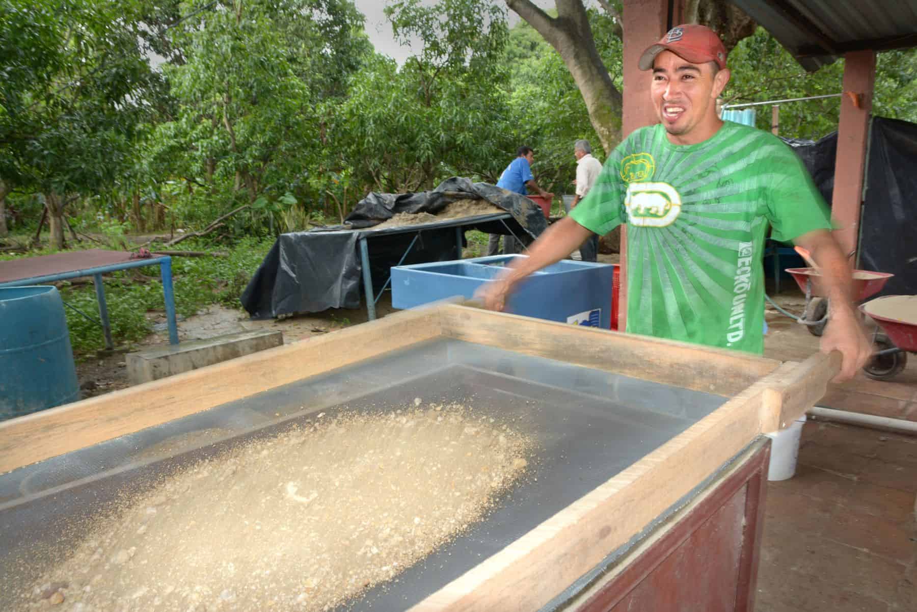 BioSand Filter recipient Dimas sifts the sand that is a key component of BioSand Filters.