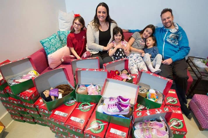 Michelle and Patrick Keogh sit with their four daughters from left; Sydney, Samara, Salem and Savannah with shoeboxes filled with school supplies, toys, clothing and hygiene items as part of the Samaritan's Purse Christmas Shoe Box campaign at their home on Monday, November 16, 2020. Salem had the idea for her family to pack 10,000 boxes on her 7th birthday, now six years later they are closing in on that goal having packed 1,200 boxes this year alone. PHOTO BY GAVIN YOUNG/POSTMEDIA