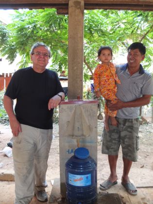 Dr David Manz stands with Mr. Theng Harn (and his granddaughter), the proud owner for the last 16 years of our first BioSand Water Filter in Cambodia. Thanks to the durability of the filter and the diligence of Theng, our partner organization, and Samaritan’s Purse to regularly maintain it, the filter is still producing clean water for Theng’s family to drink and use in their home today. Theng has lots of great things to say about living with clean water... and there are tens of thousands more stories in Cambodia that are similar to his.