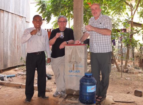 Dr. Manz (middle), Executive Director of Clear Cambodia Mr. Yim Viriya (left), and I share some water directly from 16-year-old filter #1.