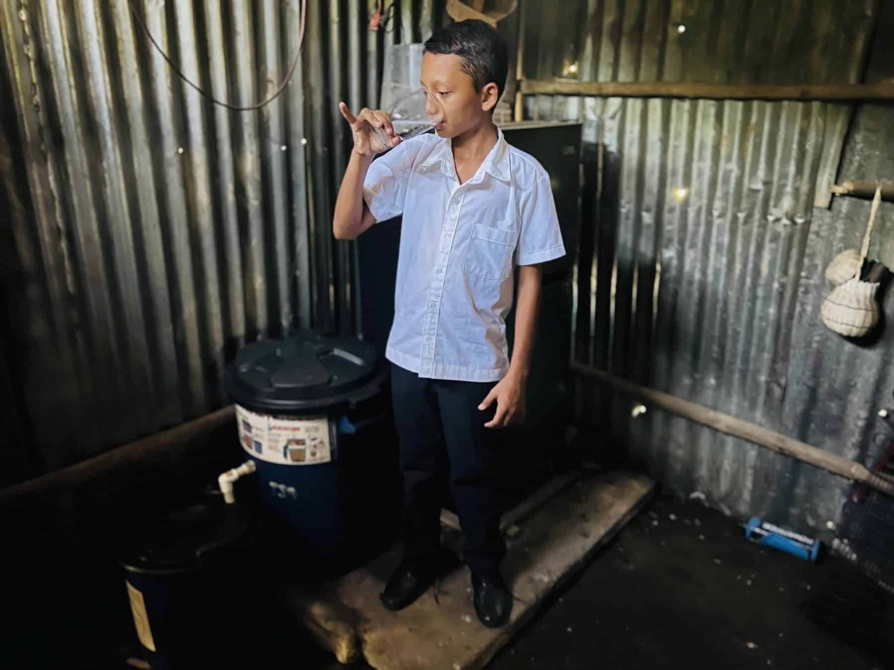 A household filter gives Hansel safe water at home.