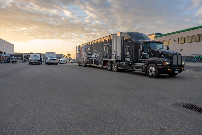 A Samaritan's Purse truck drives through a smoke-filled road.