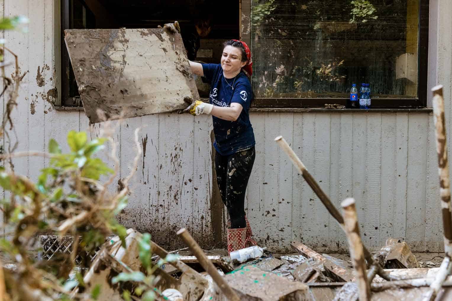 Esther Giller cleans out a damaged home.